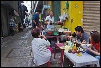 Breakfast at food stall in alley. Ho Chi Minh City, Vietnam (color)