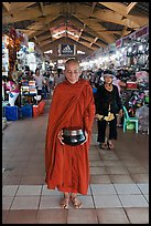 Buddhist Monk doing alms round in Ben Thanh Market. Ho Chi Minh City, Vietnam (color)