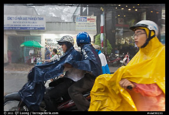 Motorcycle riders during afternoon mooson. Ho Chi Minh City, Vietnam