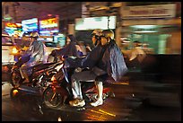 Motorcyle riders at night, dressed for the rain. Ho Chi Minh City, Vietnam ( color)