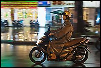 Riding motorcyle on rainy night. Ho Chi Minh City, Vietnam