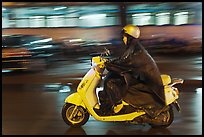 Scooter rider on rainy night. Ho Chi Minh City, Vietnam (color)