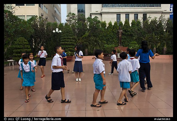 Children walking in circle in park. Ho Chi Minh City, Vietnam