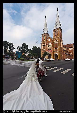 Bride with flowing dress in front of Cathedral. Ho Chi Minh City, Vietnam