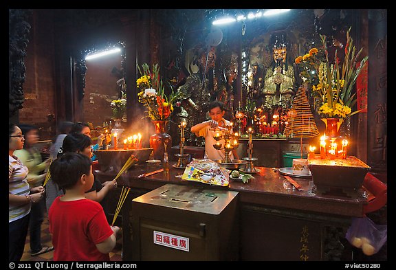 Man lightening candles, Jade Emperor Pagoda, district 3. Ho Chi Minh City, Vietnam (color)