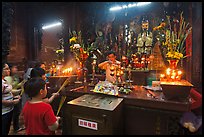 Man lightening candles, Jade Emperor Pagoda, district 3. Ho Chi Minh City, Vietnam (color)