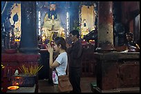 Couple worshipping Thang Hoang, Chua Ngoc Hoang pagoda, district 3. Ho Chi Minh City, Vietnam ( color)