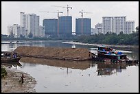 River scene and high rise towers in construction, Phu My Hung, district 7. Ho Chi Minh City, Vietnam (color)
