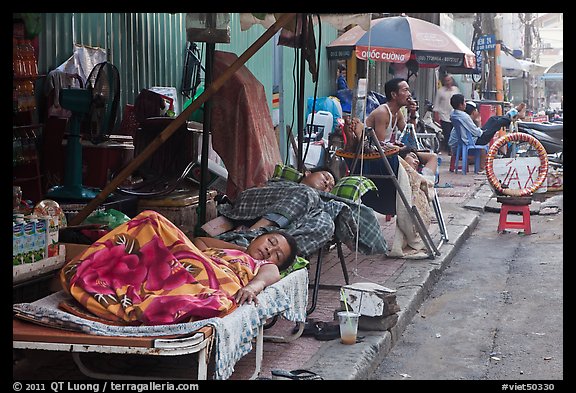 Vendors sleeping on the street at dawn. Ho Chi Minh City, Vietnam