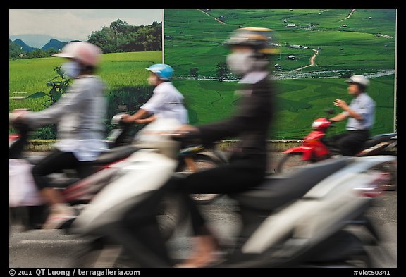 Motorbike riders speeding in front of backdrops depicting traditional landscapes. Ho Chi Minh City, Vietnam