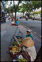 Women selling fruit on a large boulevard. Ho Chi Minh City, Vietnam ( color)