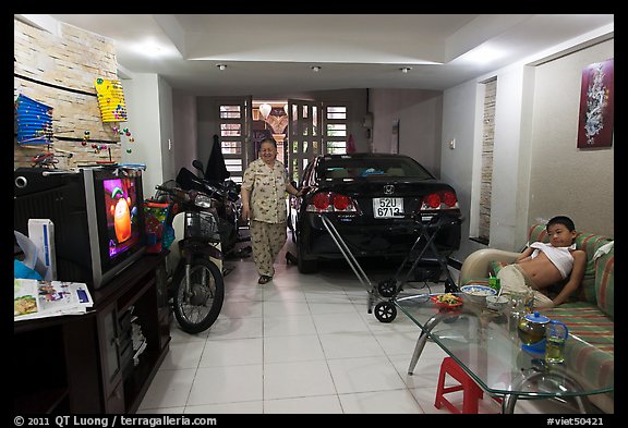 Living room used as car and motorbike garage. Ho Chi Minh City, Vietnam
