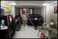 Living room used as car and motorbike garage. Ho Chi Minh City, Vietnam ( color)