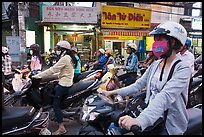 Commuters on motorcyles in stopped traffic. Ho Chi Minh City, Vietnam (color)