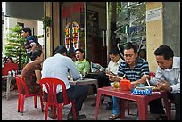 Men eating breakfast on the street. Ho Chi Minh City, Vietnam ( color)