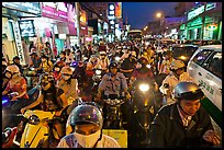 Street packed with motorcycles and vehicles at dusk. Ho Chi Minh City, Vietnam ( color)