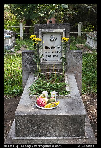 Tomb with fruit and refreshments offering. Ben Tre, Vietnam