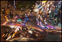 Long exposure traffic trails on busy intersection from above at night. Ho Chi Minh City, Vietnam (color)