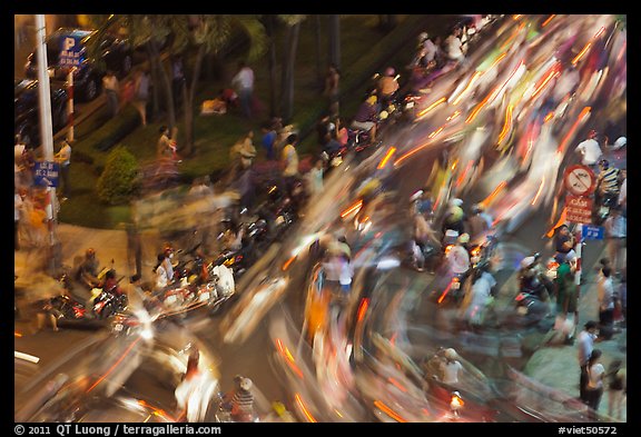 Flow of motorcycle traffic at night from above. Ho Chi Minh City, Vietnam