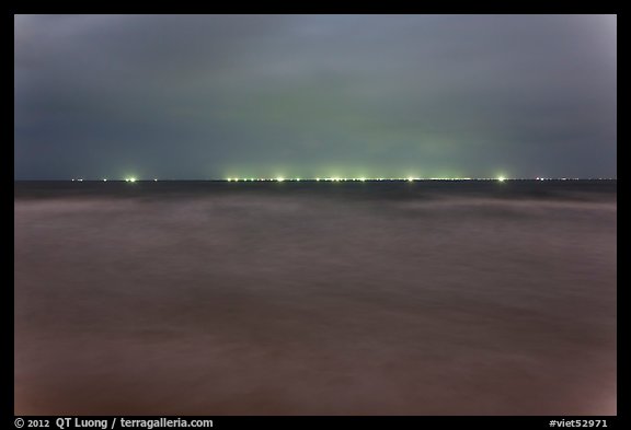 South China Sea at night with lights of fishing boats on horizon. Mui Ne, Vietnam