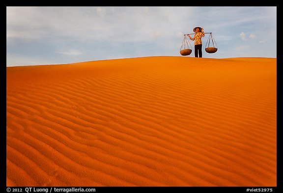 Woman on top of red sand dunes. Mui Ne, Vietnam (color)