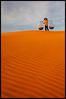 Woman on top of dune field. Mui Ne, Vietnam (color)