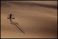Shadows of woman on dune field. Mui Ne, Vietnam (color)