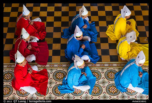 Cao Dai dignitaries wearing red (Confucian), blue (Taois) and yellow (Buddhist). Tay Ninh, Vietnam
