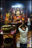 Worshippers inside Jade Emperor Pagoda. Ho Chi Minh City, Vietnam (color)