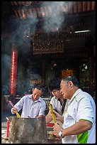Worshippers burning incense, Thien Hau Pagoda. Cholon, District 5, Ho Chi Minh City, Vietnam (color)