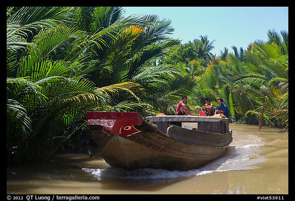 Boat navigating narrow waterway, Phoenix Island. My Tho, Vietnam