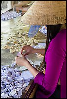 Woman wearing conical hat wrapping coconut candy, Phoenix Island. My Tho, Vietnam ( color)
