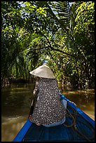 Woman rowing boat under jungle canopy, Phoenix Island. My Tho, Vietnam ( color)