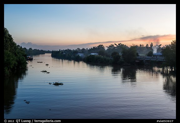 River and homes at sunset. Mekong Delta, Vietnam