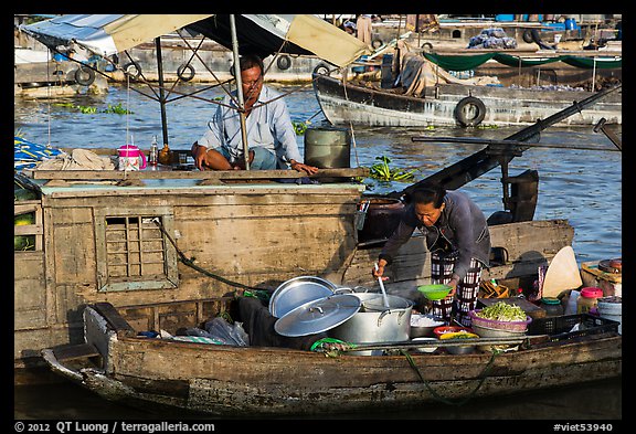 Woman serving food across boats, Cai Rang floating market. Can Tho, Vietnam