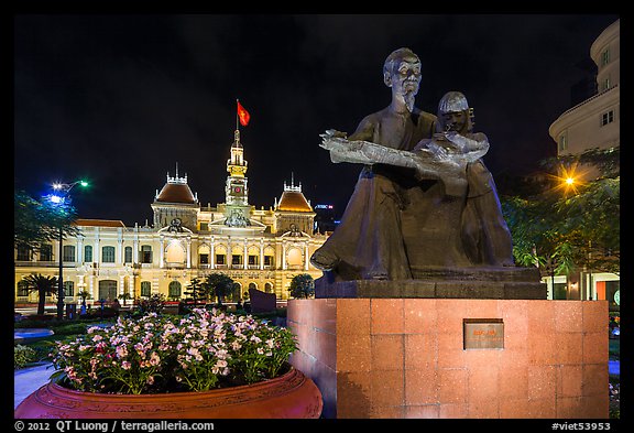 Ho Chi Minh as teacher bronze by Diep Minh Chau and City Hall by night. Ho Chi Minh City, Vietnam