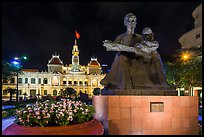 Ho Chi Minh as teacher bronze by Diep Minh Chau and City Hall by night. Ho Chi Minh City, Vietnam (color)