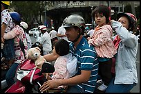 Family on motorbike watching musical performance. Ho Chi Minh City, Vietnam ( color)