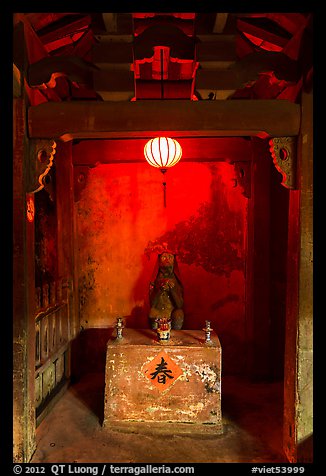 Monkey altar lit by lantern, Japanese Bridge. Hoi An, Vietnam