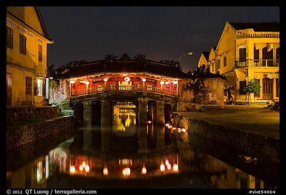 Covered Japanese Bridge reflected in canal by night. Hoi An, Vietnam (color)