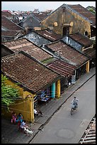 Elevated view of street with woman on bicycle. Hoi An, Vietnam (color)