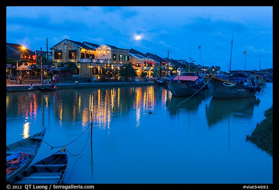 Waterfront, boats, and Thu Bon River at dusk. Hoi An, Vietnam