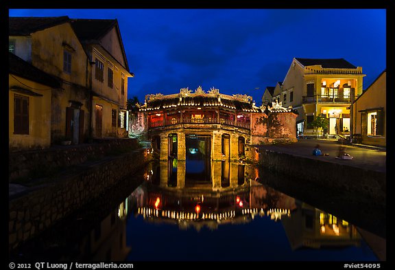 Japanese covered bridge reflected in canal at night. Hoi An, Vietnam