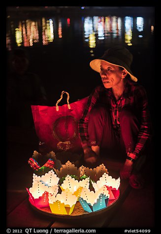 Woman selling floating candles at night. Hoi An, Vietnam (color)