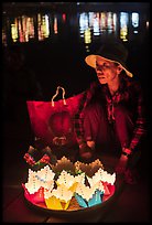 Woman selling floating candles at night. Hoi An, Vietnam (color)