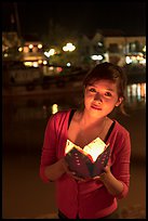 Woman holding candle box at night. Hoi An, Vietnam ( color)