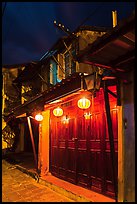 Townhouse with wooden doors lighted by paper lanterns. Hoi An, Vietnam (color)