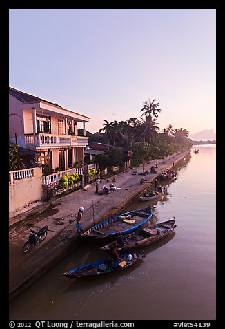 Waterfront and quay with vendors at sunrise. Hoi An, Vietnam (color)