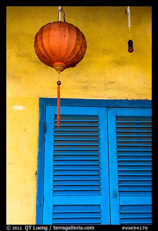 Paper lantern, wall, and blue shutters. Hoi An, Vietnam