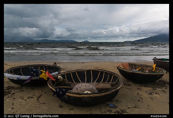 Coracle boats on beach during storm. Da Nang, Vietnam
